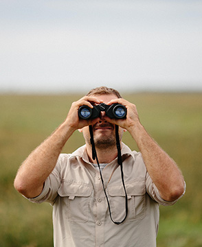 Man looking through binoculars