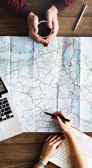 A couple planning travel over a map